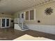 Spacious carport with convenient access to the home, and a sun decoration on the wall at 8700 E University Dr # 1024, Mesa, AZ 85207
