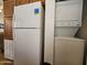 Bright kitchen includes white refrigerator and a stacked washer and dryer at 8700 E University Dr # 1024, Mesa, AZ 85207