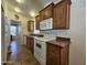 Functional kitchen with wooden cabinets, white appliances, and ample counter space at 8700 E University Dr # 1024, Mesa, AZ 85207