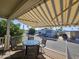 Relaxing patio featuring a round table, four chairs, and overhead awning, perfect for outdoor enjoyment at 8700 E University Dr # 1024, Mesa, AZ 85207
