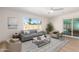 Inviting living room with neutral tones, a large window overlooking the backyard, and stylish decor at 8732 E Forest Dr, Scottsdale, AZ 85257
