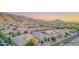 Scenic aerial view of a neighborhood with mountain backdrops at sunset at 8911 S 14Th Way, Phoenix, AZ 85042