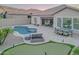 Backyard with a swimming pool, putting green, covered patio, and mountain views at 8911 S 14Th Way, Phoenix, AZ 85042