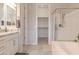 Bright bathroom features a soaking tub, glass-enclosed shower, and walk-in closet at 8911 S 14Th Way, Phoenix, AZ 85042