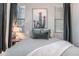 Serene bedroom showcasing a cactus art piece, soft gray tones, and natural light at 8911 S 14Th Way, Phoenix, AZ 85042