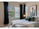 Inviting bedroom with large windows, green accents, and a comfortable bed at 8911 S 14Th Way, Phoenix, AZ 85042