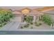 Single Gathering home with stone accents, desert landscaping, and a three car garage at 8911 S 14Th Way, Phoenix, AZ 85042