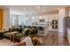Open concept kitchen with a large island, stainless steel appliances, and a dining area at 8911 S 14Th Way, Phoenix, AZ 85042