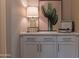 Living room with a stylish lamp, modern credenza, and a cactus print at 8911 S 14Th Way, Phoenix, AZ 85042