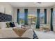 Bedroom features plush bedding, backyard views, and a cozy seating area at 8911 S 14Th Way, Phoenix, AZ 85042