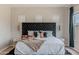 Bedroom features a stylish headboard, a plush bed, and a view of the window at 8911 S 14Th Way, Phoenix, AZ 85042