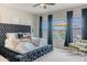 Main bedroom showcases a tufted headboard, plush bedding, and views of the backyard patio at 8911 S 14Th Way, Phoenix, AZ 85042