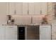Modern wet bar featuring a wine refrigerator, white cabinets, and a granite countertop at 8911 S 14Th Way, Phoenix, AZ 85042