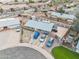 Aerial view of the house, showing the driveway, many cars, landscaping, and surrounding neighborhood at 907 N Menze St, Casa Grande, AZ 85122