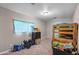 Bedroom with bunkbeds, carpeted floors, toys, and natural light through the window at 907 N Menze St, Casa Grande, AZ 85122