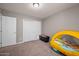 Bedroom featuring carpet floors, a car-shaped bed, closet, and a white door at 907 N Menze St, Casa Grande, AZ 85122