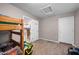 Bedroom featuring carpet floors, white doors, and a bunkbed, adjacent to the kitchen at 907 N Menze St, Casa Grande, AZ 85122
