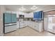 Modern kitchen with white cabinets, stainless appliances, and granite countertops, providing style and function at 907 N Menze St, Casa Grande, AZ 85122