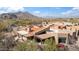 Breathtaking aerial view of a home nestled among mountains, highlighting its prime location and unique architectural details at 9110 E Clubhouse Ct # 639, Scottsdale, AZ 85262