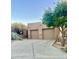 Southwest home with mature desert landscaping, and a two-car garage with a concrete driveway at 9110 E Clubhouse Ct # 639, Scottsdale, AZ 85262