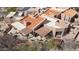 An aerial view of an adobe home featuring a tile roof and covered patio with desert landscaping at 9110 E Clubhouse Ct # 639, Scottsdale, AZ 85262