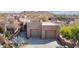 Attractive home exterior featuring a two-car garage, desert landscaping, and a well-maintained front yard at 9110 E Clubhouse Ct # 639, Scottsdale, AZ 85262