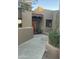 Charming front entrance with a wooden door, slat window, and potted desert plants at 9110 E Clubhouse Ct # 639, Scottsdale, AZ 85262