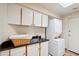 Laundry room with upper and lower cabinet storage and a stacked washer and dryer at 9110 E Clubhouse Ct # 639, Scottsdale, AZ 85262