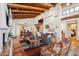 Open-concept living space with beamed ceilings, fireplace, and an adjacent kitchen at 9110 E Clubhouse Ct # 639, Scottsdale, AZ 85262