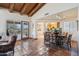 Open floor plan with terracotta tile, wood beams, and a view into the kitchen at 9110 E Clubhouse Ct # 639, Scottsdale, AZ 85262