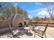 Inviting outdoor patio with a cozy fireplace and comfortable seating, perfect for relaxing and enjoying the desert landscape at 9110 E Clubhouse Ct # 639, Scottsdale, AZ 85262