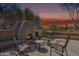 Inviting outdoor patio with a cozy fireplace and comfortable seating, perfect for relaxing and enjoying the desert landscape at 9110 E Clubhouse Ct # 639, Scottsdale, AZ 85262