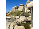 Rock waterfall flowing into a pond near tables, chairs and umbrellas at 9110 E Clubhouse Ct # 639, Scottsdale, AZ 85262