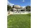 Community pool with lounge chairs surrounded by well-manicured landscaping and a clubhouse at 9110 E Clubhouse Ct # 639, Scottsdale, AZ 85262