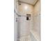 Bathroom shower with tiled walls, a built-in shower seat, and pebble accents at 9110 E Clubhouse Ct # 639, Scottsdale, AZ 85262