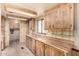 Kitchen featuring wooden cabinets, stylish countertops, and plenty of light at 9139 E Aspen Ave, Mesa, AZ 85208