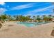 A large, sparkling community pool with lounge chairs and palm tree landscaping at 925 S Storment Ln, Gilbert, AZ 85296