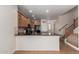 Modern kitchen featuring a breakfast bar, granite countertops, wood cabinets, and stainless steel appliances at 925 S Storment Ln, Gilbert, AZ 85296