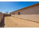 Exterior backyard featuring a private block wall, and an undeveloped yard at 9630 E Hay Loft Dr, Florence, AZ 85132