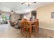 Open-concept room showing the dining area with a ceiling fan and casual living area at 9630 E Hay Loft Dr, Florence, AZ 85132