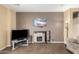 Cozy living room featuring a stone fireplace, and tan walls at 9630 E Hay Loft Dr, Florence, AZ 85132