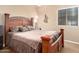 Comfortable bedroom with a wooden bed frame and plush bedding at 9630 E Hay Loft Dr, Florence, AZ 85132