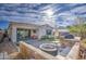 Backyard featuring artificial turf, pavers, a built-in grill, and string lights at 9818 E Talon Ave, Mesa, AZ 85212