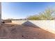 Spacious backyard featuring a block wall and desert landscaping, offering privacy and a low-maintenance outdoor space at 1060 W Castle Ct, Casa Grande, AZ 85122