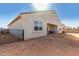 Exterior view of the backyard with a covered patio and a wrought iron fence at 1060 W Castle Ct, Casa Grande, AZ 85122