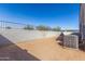 View of the backyard showcasing the desert landscaping and air conditioning unit at 1060 W Castle Ct, Casa Grande, AZ 85122