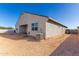 Back exterior view of the home featuring the patio and central air conditioning unit at 1060 W Castle Ct, Casa Grande, AZ 85122