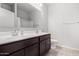 Bathroom features a double sink vanity with dark cabinets and tile flooring at 1060 W Castle Ct, Casa Grande, AZ 85122