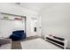 Bright bedroom with a cozy beanbag, closet, and modern media stand at 1060 W Castle Ct, Casa Grande, AZ 85122