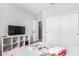 Cozy bedroom with sleek white closet doors, a modern TV stand, and neutral gray walls at 1060 W Castle Ct, Casa Grande, AZ 85122